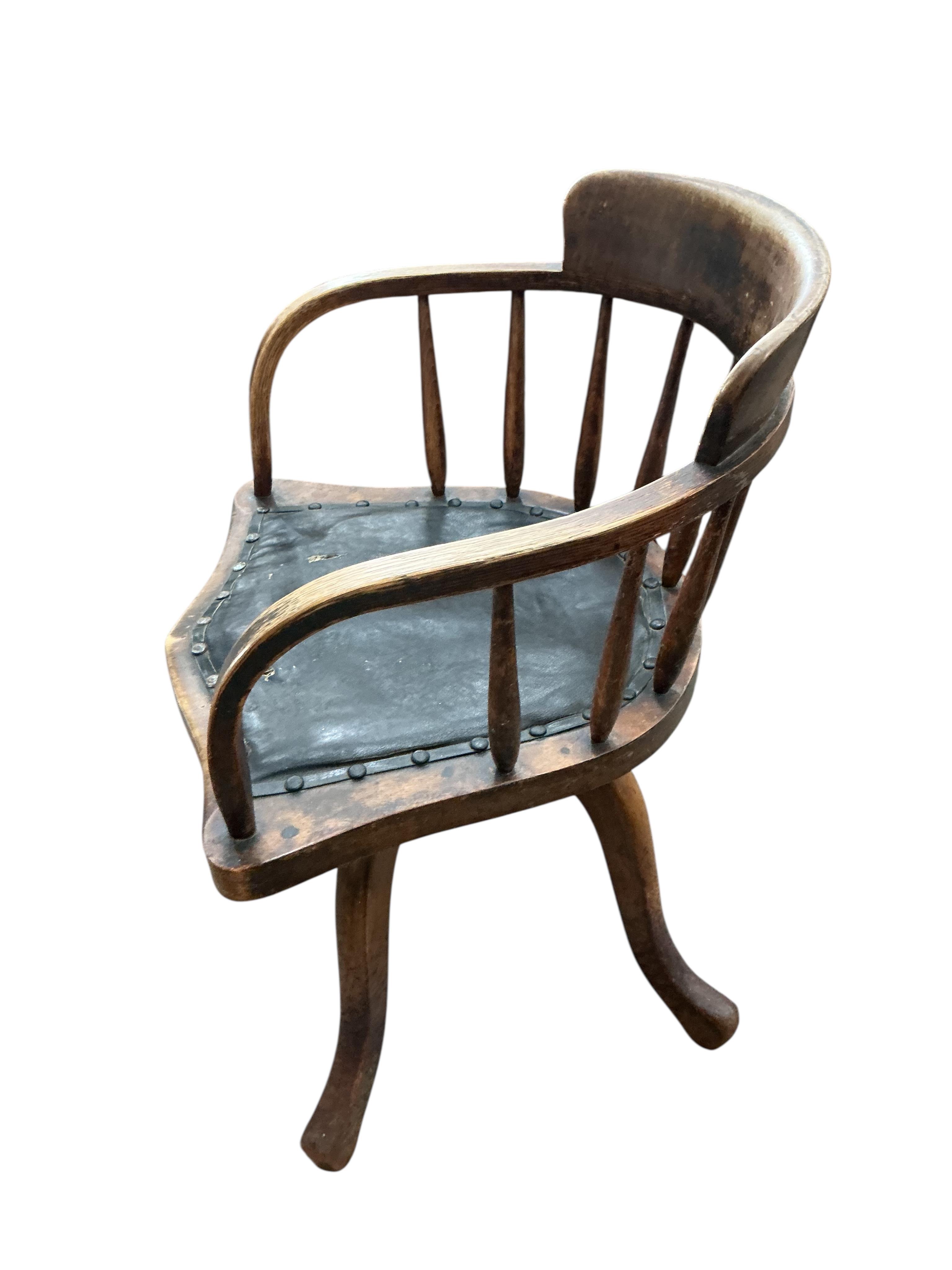 An early 20th century ash and beech revolving desk chair, width 55cm, depth 45cm, height 76cm